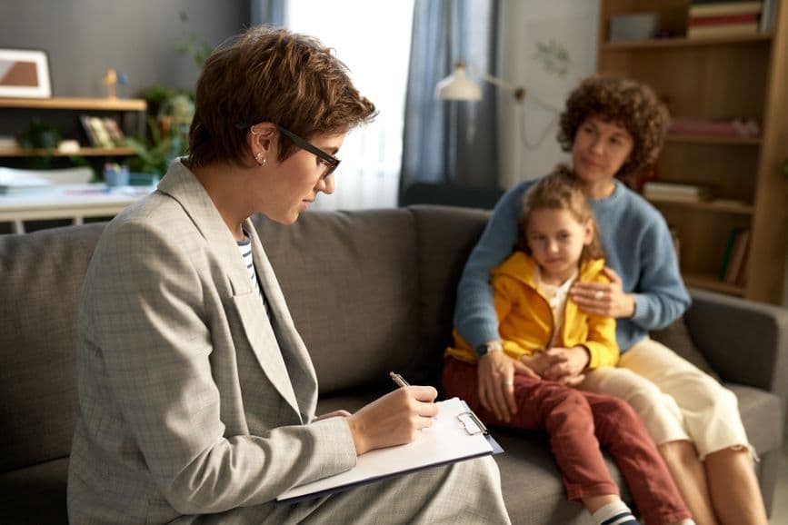 Social worker talking to family at home
