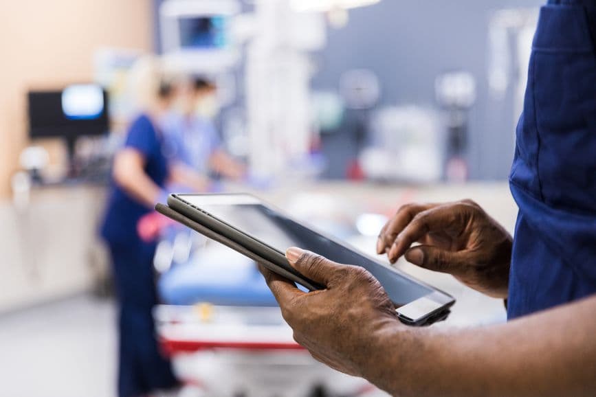 A close up of someone using a tablet in a clinical environment